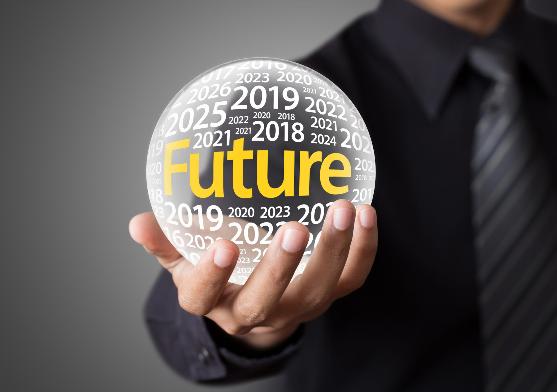 Businessman holding a glass ball,foretelling the future.